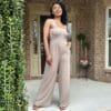 Image of the Kennedi Jumpsuit featuring a flattering smocked bodice and wide-leg pants with convenient pockets, designed for effortless style and comfort, perfect for any occasion.