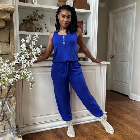 Image of a sleeveless jogger jumpsuit made from super stretchy fabric, featuring a roomy fit, functional buttons, and convenient pockets, perfect for lounging at home or casual outings in effortless style.